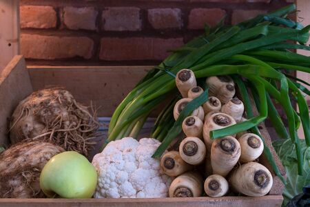 Assorted fresh green vegetables in boxes at a farmers market after harvestの写真素材
