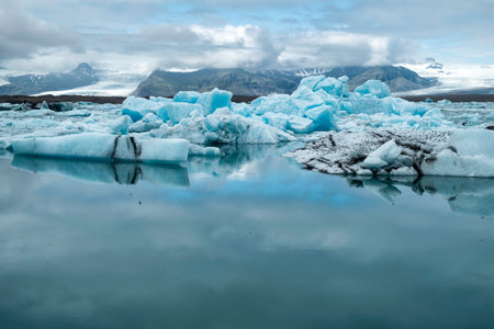 Blue icebergs floating the glacial lagoon in southeast Iceland in summer, blue water in the...