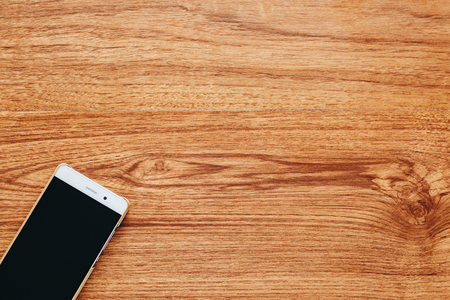 Smart phone on wooden background.の写真素材
