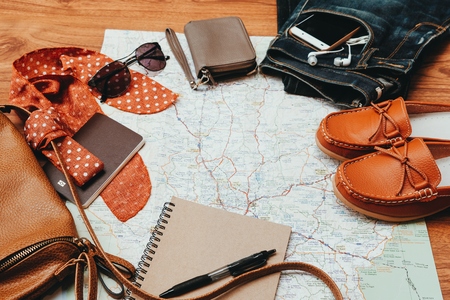 Clothing for woman and travel accessories on wooden background.の写真素材