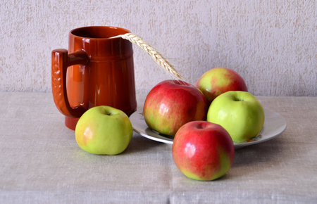 beer mug and an apple on a plateの写真素材