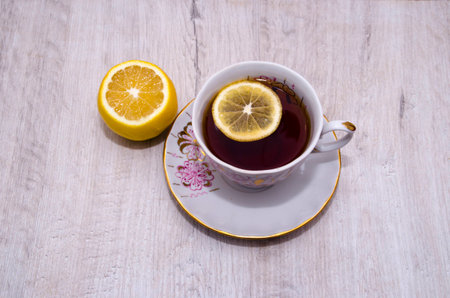 cup of tea with lemon on a saucerの写真素材