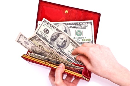 Dollars in red wallet and woman hands isolated on whiteの写真素材