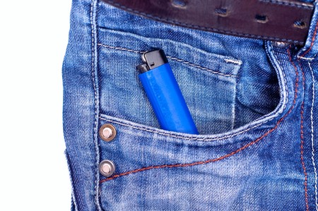 Blue lighter in blue jeans pocket. White backgroundの写真素材