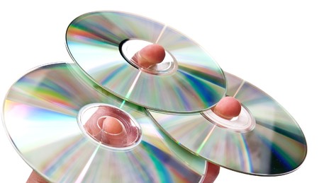 Three dvd disks on hand. Isolated on white backgroundの写真素材