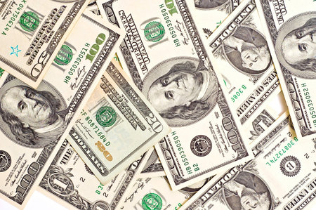 A scattered pile of hundred, one, fifty, twenty dollar bills.
