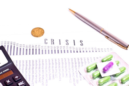 The crisis graph, pills and silver pen. white background