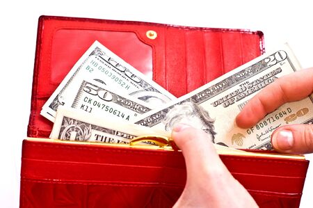 Dollars in red wallet and woman hands isolated on whiteの写真素材