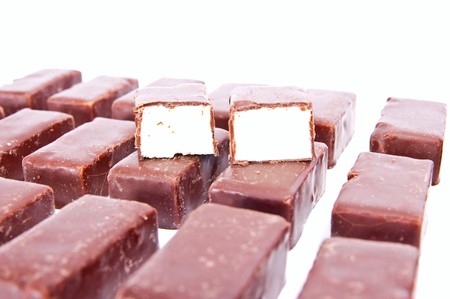 rows from chocolate candies isolated on white backgroundの写真素材