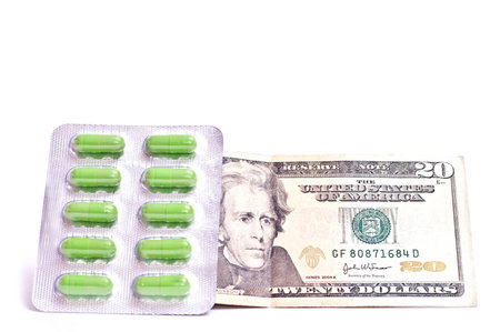 Green pills with dollar isolated on white