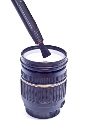 camera lens with lens cleaning brush pen on white backgroundの写真素材