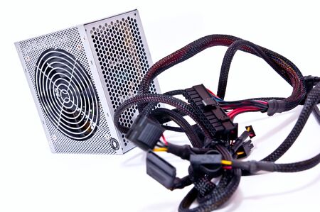Computer power supply with wires on white background.の写真素材