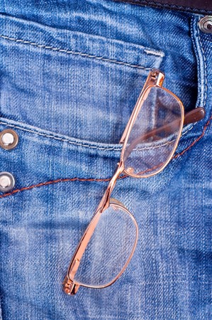 Gold glasses in blue jeans double pocketの写真素材