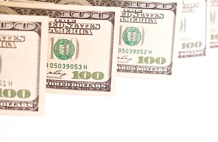 money row from one hundred dollar bank-papers on white