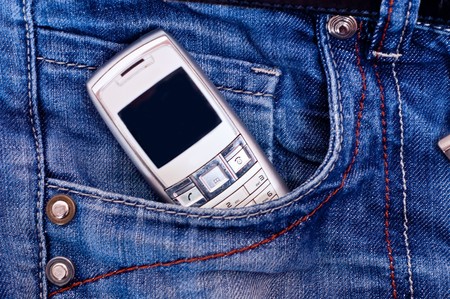 Cell phone in pocket of blue jeans.の写真素材