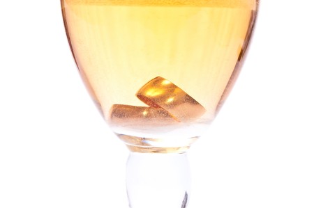 Gold rings in champagne isolated on whiteの写真素材