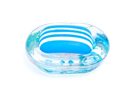 A glass soapdish with blue soap isolated on whiteの写真素材