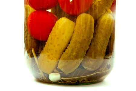 A jar of pickles and tomato, isolated on whiteの写真素材