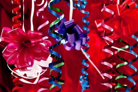 Beautiful christmas bows and ribbons on red backgroundの写真素材