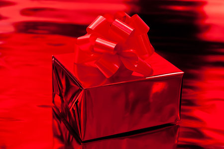 One red christmas presents. Red backgroundの写真素材