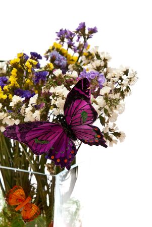 Flowers in glass vase with butterflies. Isolated on whiteの写真素材