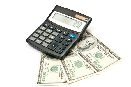 Calculator and couple of 100 dollars, isolated on white.の写真素材