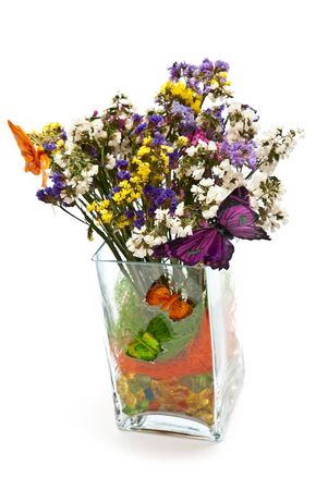 Flowers in glass vase with butterflies. Isolated on whiteの写真素材