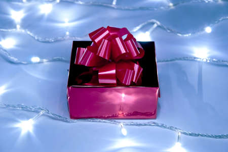 Red gift box with bow and white garlandの写真素材