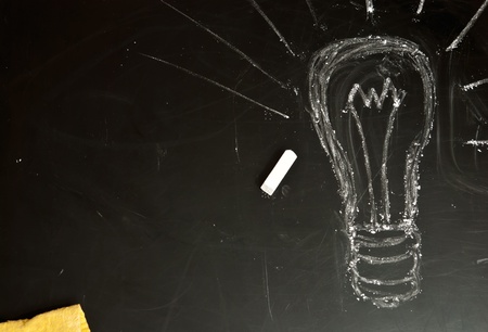 Light bulb drawn on a blackboard, symbolizing ideas and creativityの写真素材