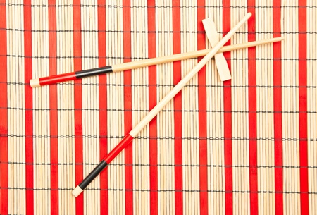 Red and black sticks for sushi on bamboo backgroundの写真素材