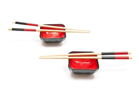 Black and red sushi set (chopsticks and plate) isolated on white backgroundの写真素材