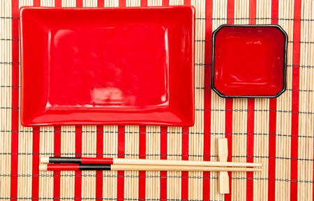 Red and black empty sushi set on the bamboo backgroundの写真素材