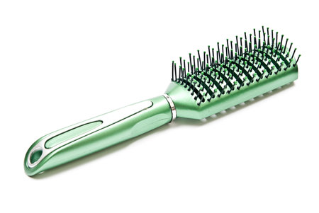 Green plastic comb isolated on white backgroundの写真素材