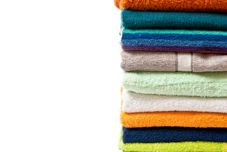 Pile of bright color towels isolated on withe backgroundの写真素材