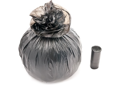 One black garbage bag isolated on white. Soft shadowの写真素材