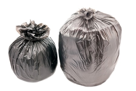 Two black garbage bags isolated on whiteの写真素材