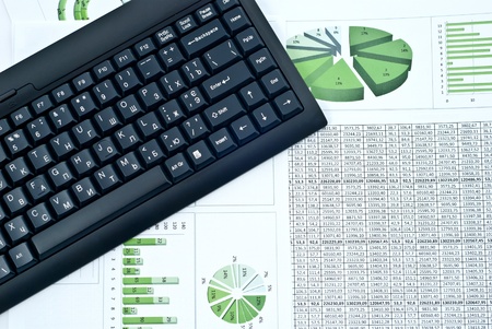 Black keyboard on a stock green chart and numbers. Studio shotの写真素材