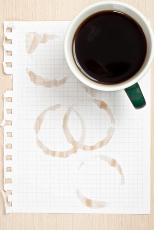 Coffee rings and cup of coffee stains on white paper backgroundの写真素材