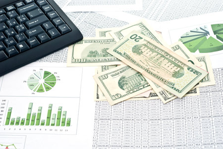 Black keyboard, mouse and dollars on a stock chart