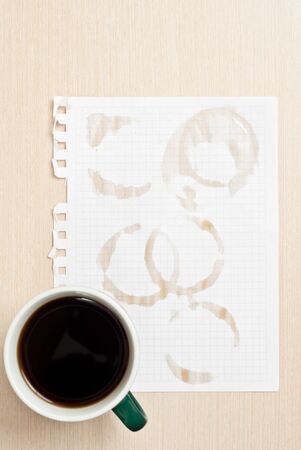 Coffee rings and cup of coffee stains on white paper backgroundの写真素材