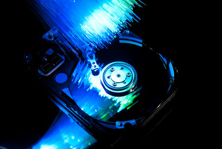 Hard disc with fiber optics background. Studio shot