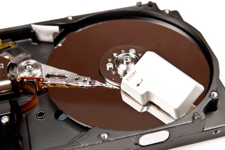 Hard disk with enter key. On white backgroundの写真素材