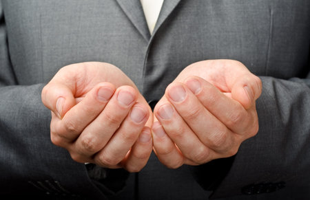 Businessman hands as if holding something. Focus on finger-tipsの写真素材
