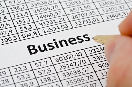 Business background, financial data concept with numbers and hand with penの写真素材