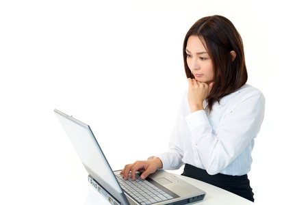 The female office worker who is lost in thought in front of a PCの写真素材