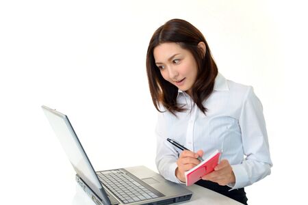 The female office worker who works with a computerの写真素材