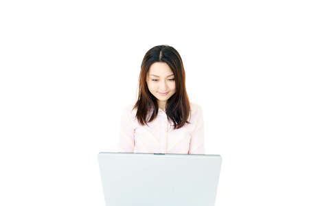 The female office worker who works with a computerの写真素材