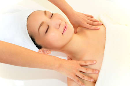 Woman receives body massage at spa salonの写真素材