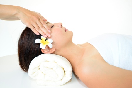 Pretty woman receiving facial massageの写真素材