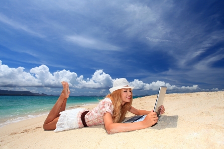 The woman who relaxes on the beach の写真素材